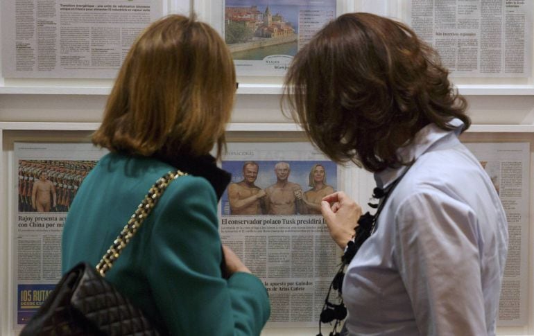 A woman points at an art piece depicting several political leaders, including European Council President Donald Tusk (L), his predecessor Herman Van Rompuy and European Union Foreign Policy Chief Federica Mogherini (R), by Peruvian artist Sandra Gamarra d