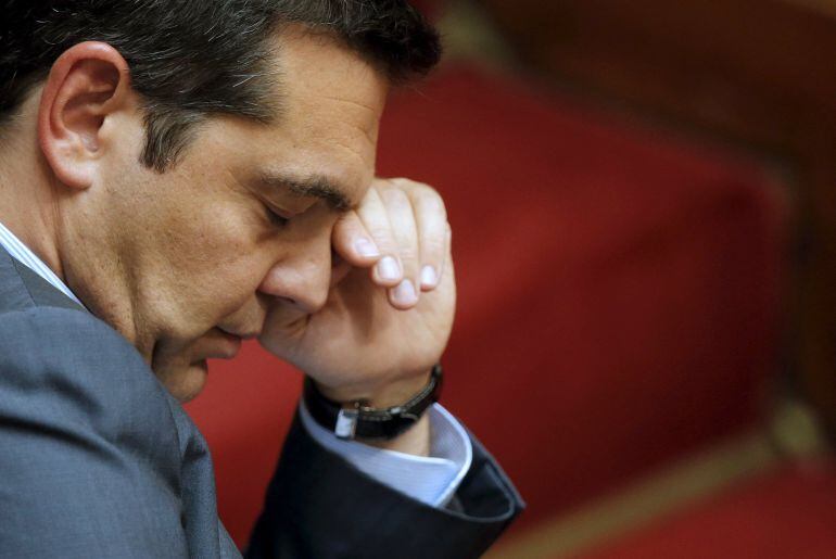 Greek Prime Minister Alexis Tsipras reacts as he attends the end of a night parliamentary session in Athens, Greece, August 14, 2015. Tsipras urged lawmakers to approve an 85-billion-euro bailout agreement with creditors on Friday, calling it a &quot;necessary