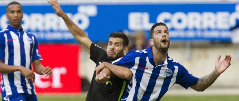 Edgar Mendez, del Deportivo Alavés, lucha por el balón con Carlos Carmona del Sporting de Gijón.