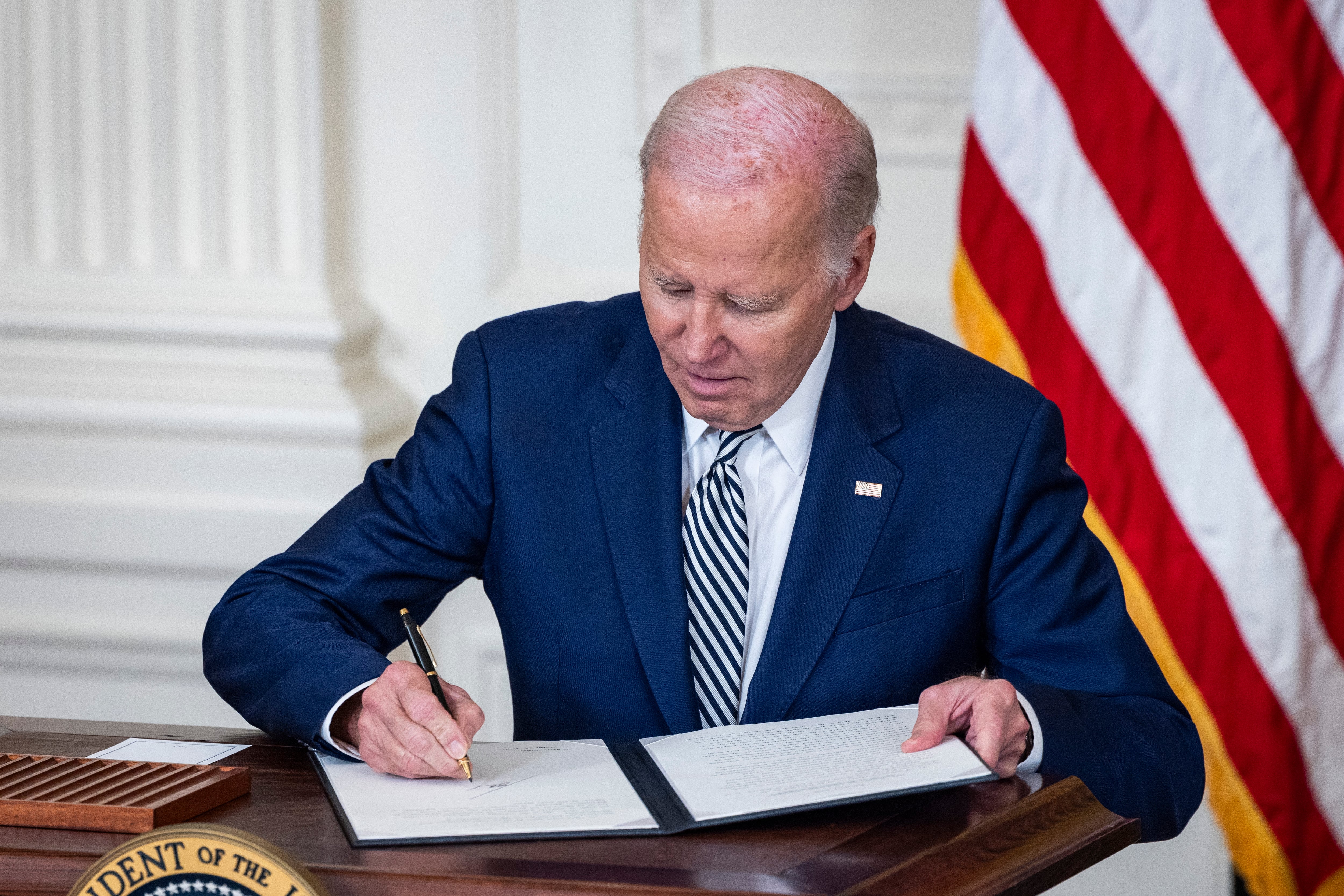 Momento en el que Joe Biden firma la orden ejecutiva para controlar el desarrollo de sistemas de inteligencia artificial