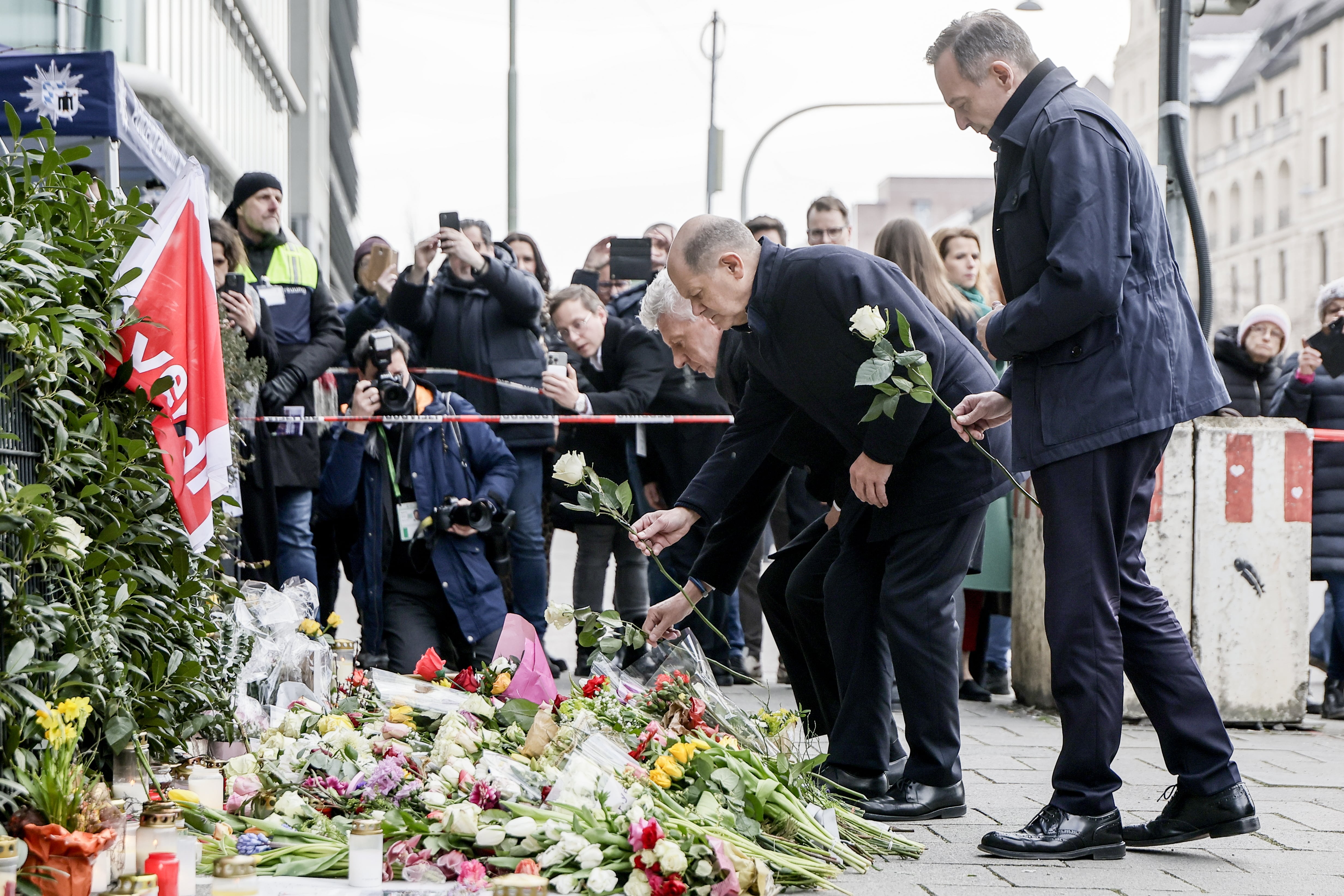 El canciller alemán Olaf Scholz deposita flores en el lugar de los hechos tras el atentado que ha dejado dos personas muertas en Múnich, Alemania. EFE/EPA/RONALD WITTEK