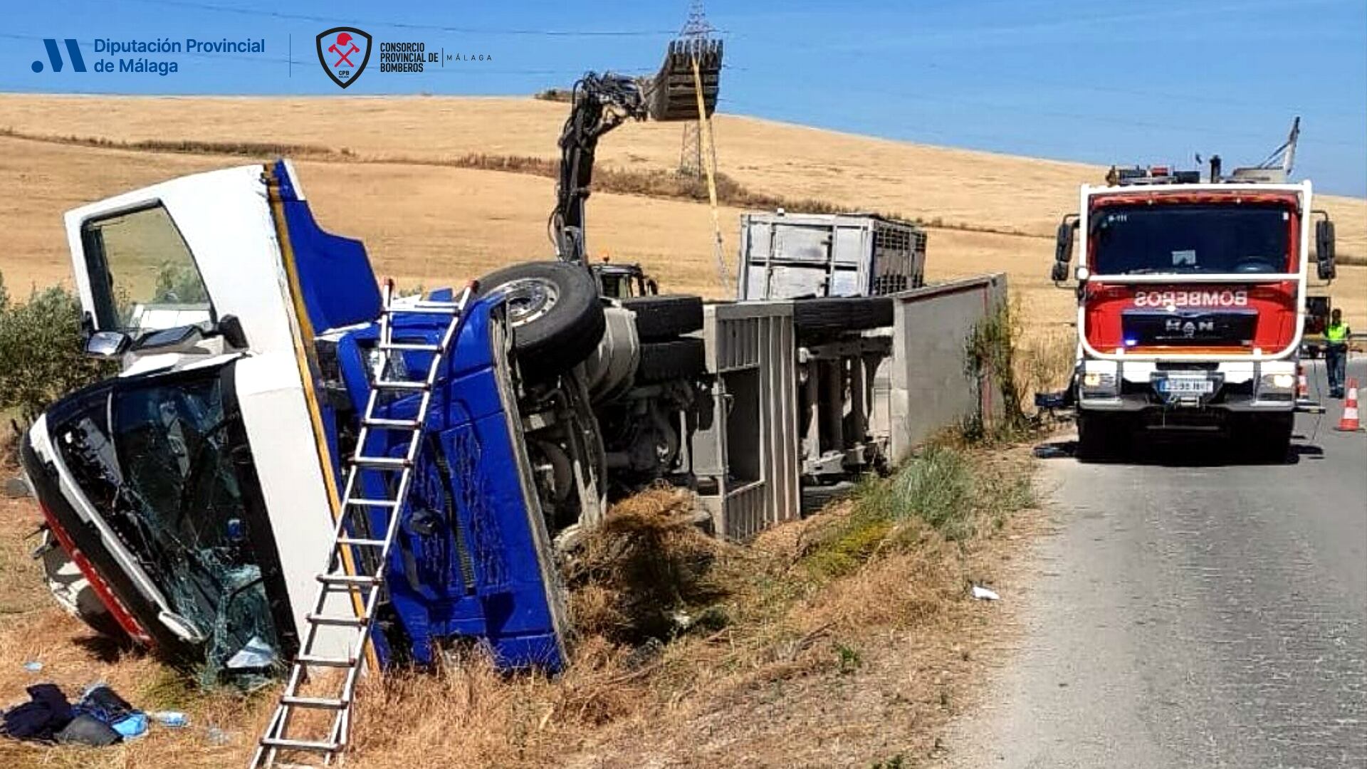 Intervención de los bomberos en el accidente de un camión cargado de ganado porcino en Teba