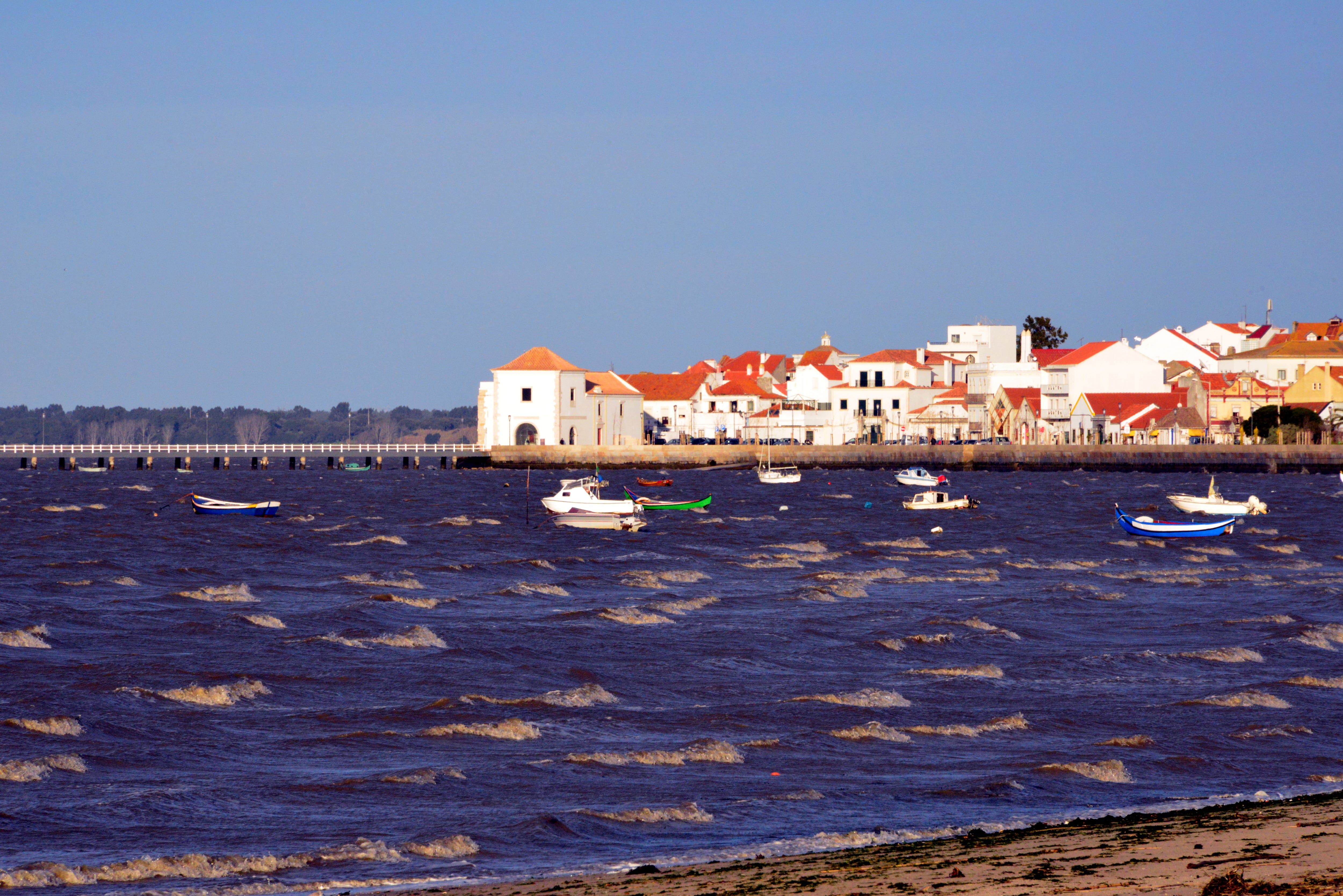 Alcochete, Portugal: the old town skyline - town center waterfront on the Tagus river - boats and pier