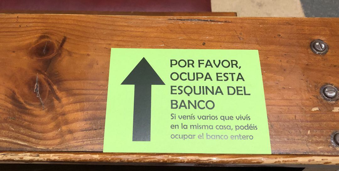 Carteles pegados en un banco de un templo religioso de la provincia de Jaén.