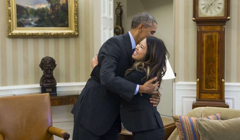 US President Barack Obama hugs nurse Nina Pham, who was declared free of the Ebola virus after contracting the disease while caring for a Liberian patient in Texas, during a meeting in the Oval Office of the White House in Washington, DC, October 24, 2014