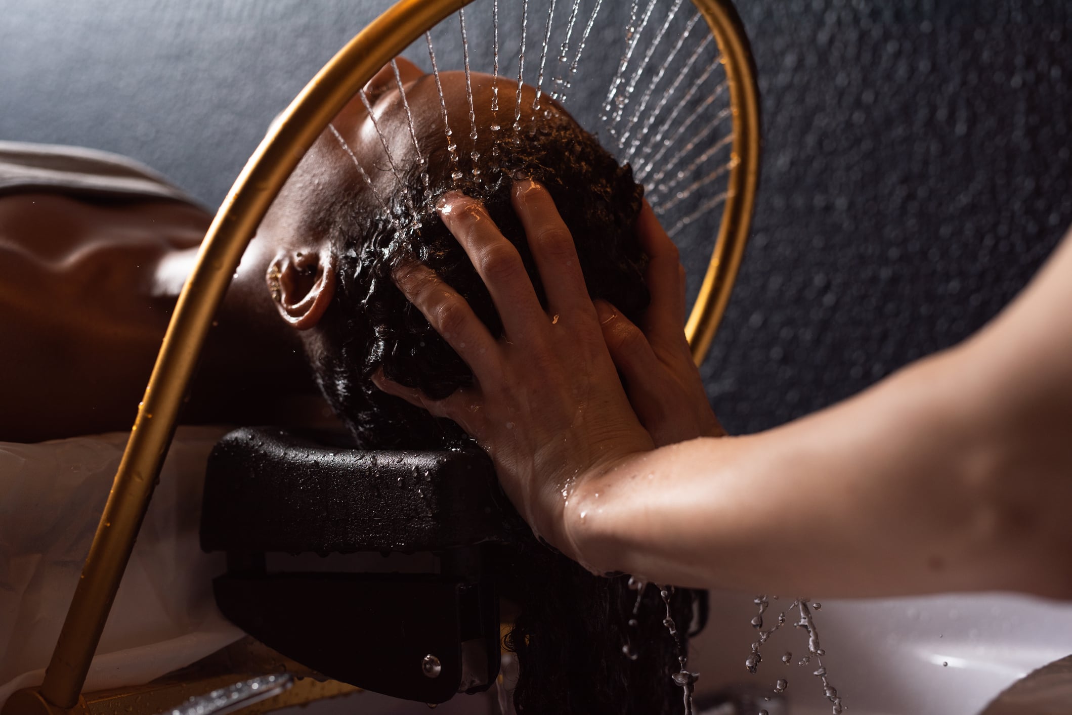 Close up of relaxing hair wash at a salon.