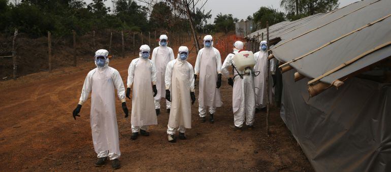 DISCO HILL, LIBERIA - JANUARY 27:  A burial team awaits decontamination at the U.S.-built cemetery for &quot;safe burials&quot; on January 27, 2015 in Disco Hill, Liberia. The cemetery, operated by USAID-funded Global Communities, has buried almost 300 people in it