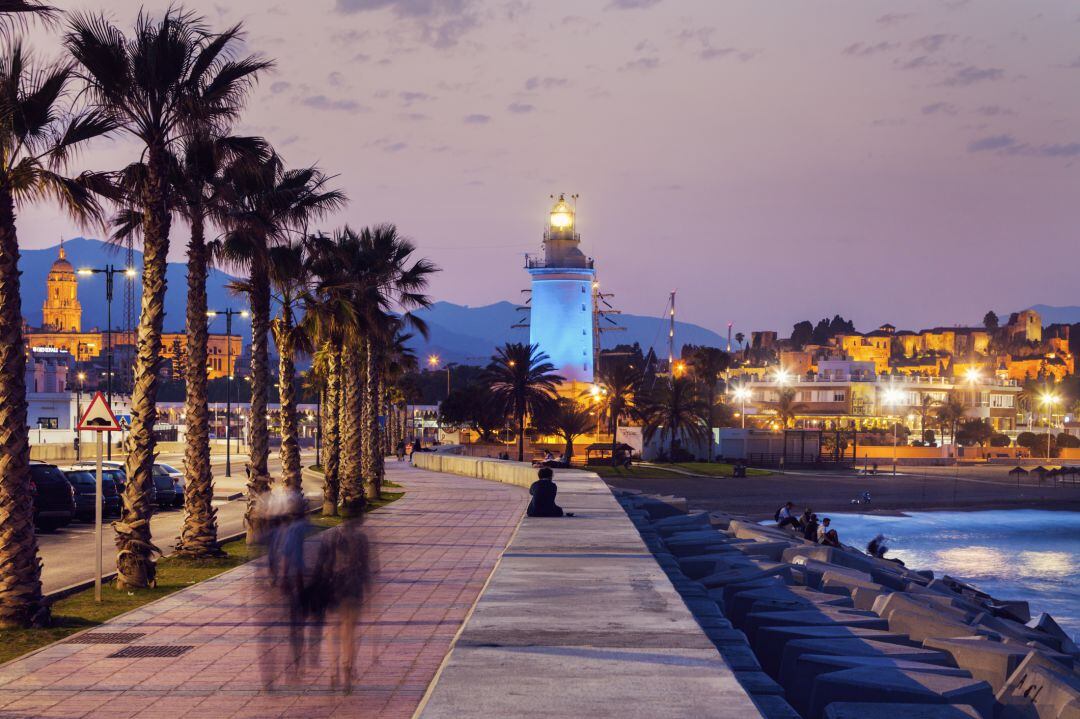 Imagen de un atardecer en Málaga, al fondo La Farola