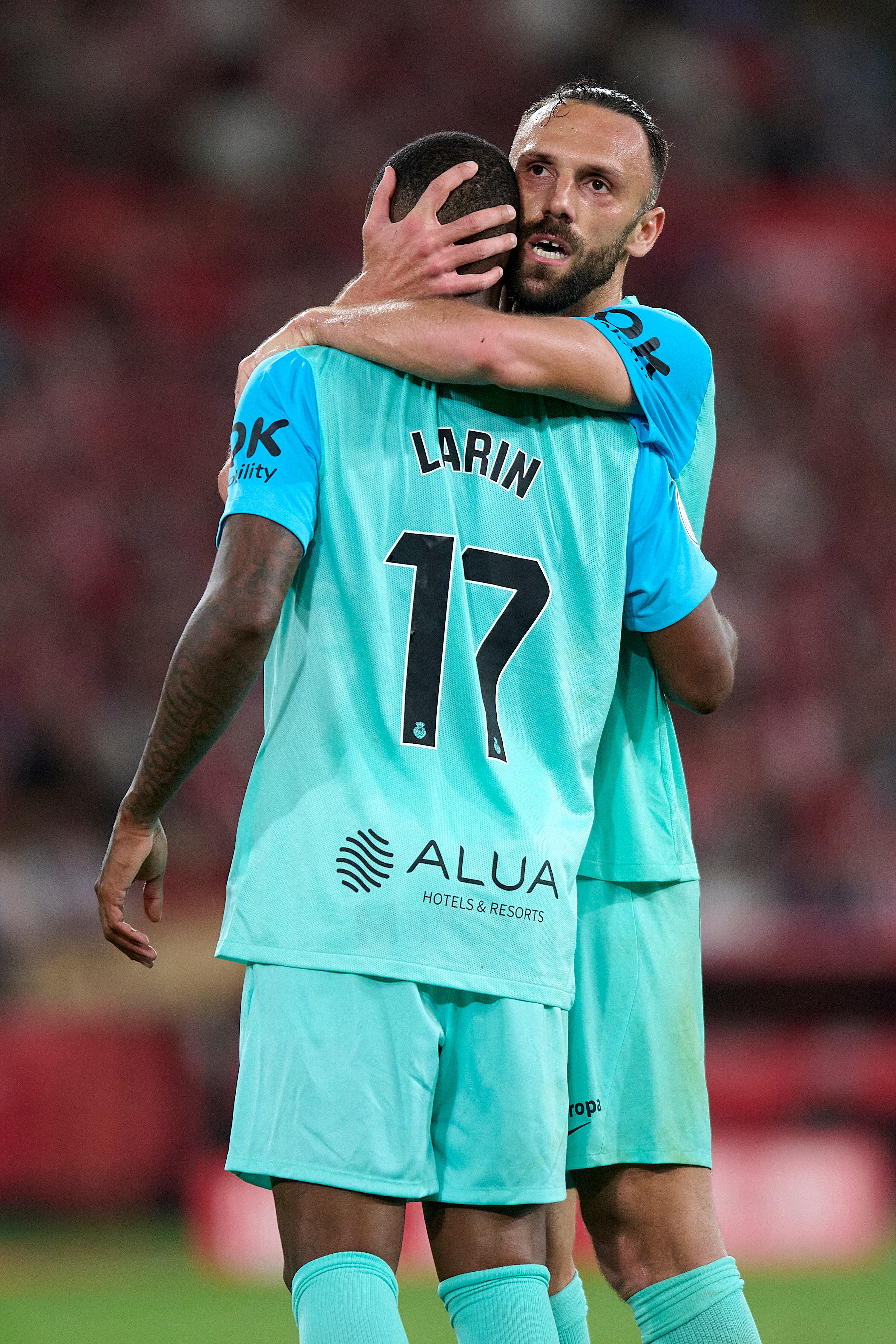 SEVILLE, SPAIN - APRIL 06: Vedat Muriqi of RCD Mallorca and Cyle Larin of RCD Mallorca embrace during the Copa Del Rey Final match between Athletic Club and Real Mallorca at Estadio de La Cartuja on April 06, 2024 in Seville, Spain. (Photo by Cristian Trujillo/Quality Sport Images/Getty Images)