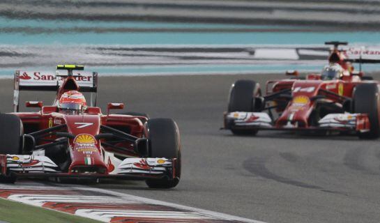 Ferrari driver Kimi Raikkonen of Finland leads his teammate Fernando Alonso of Spain during the Emirates Formula One Grand Prix at the Yas Marina racetrack in Abu Dhabi, United Arab Emirates, Sunday, Nov. 23, 2014. (AP Photo/Hassan Ammar)