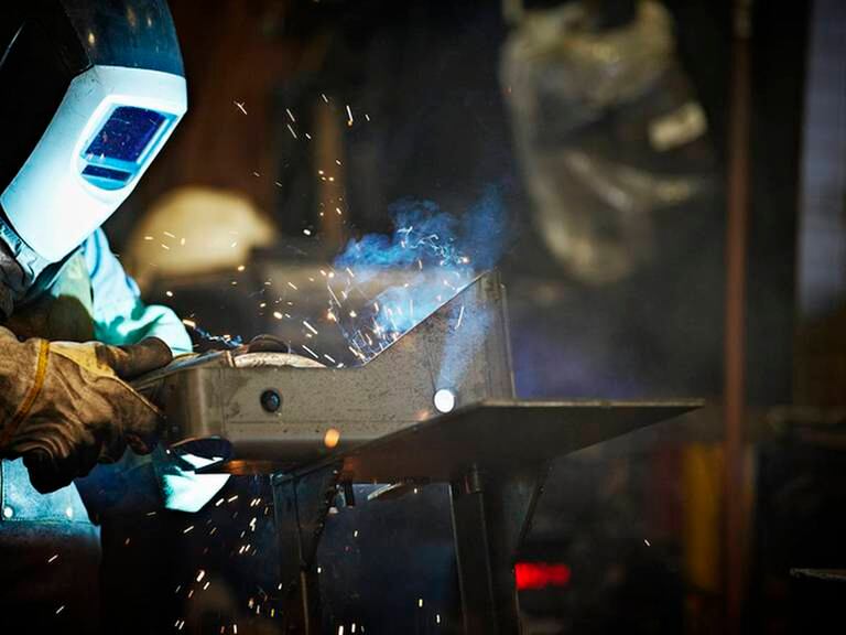 Welder working in steel manufacturing facility