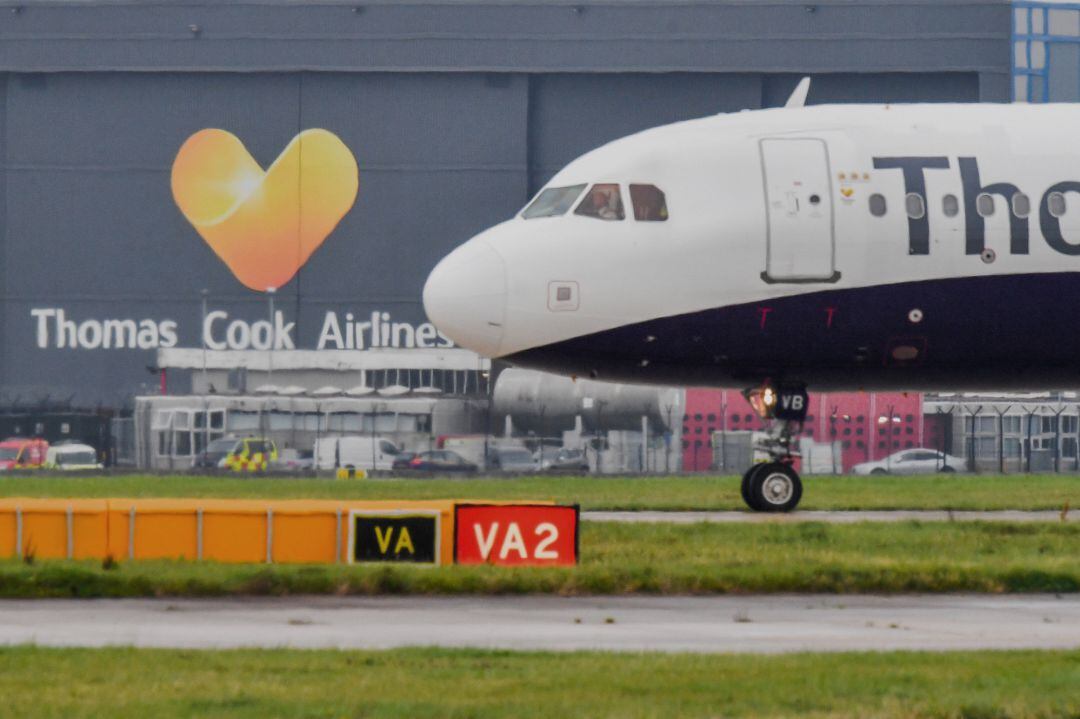 MANCHESTER, ENGLAND - SEPTEMBER 22: A Thomas Cook aircraft awaits departure on the runway at Terminal 1 at Manchester Airport 