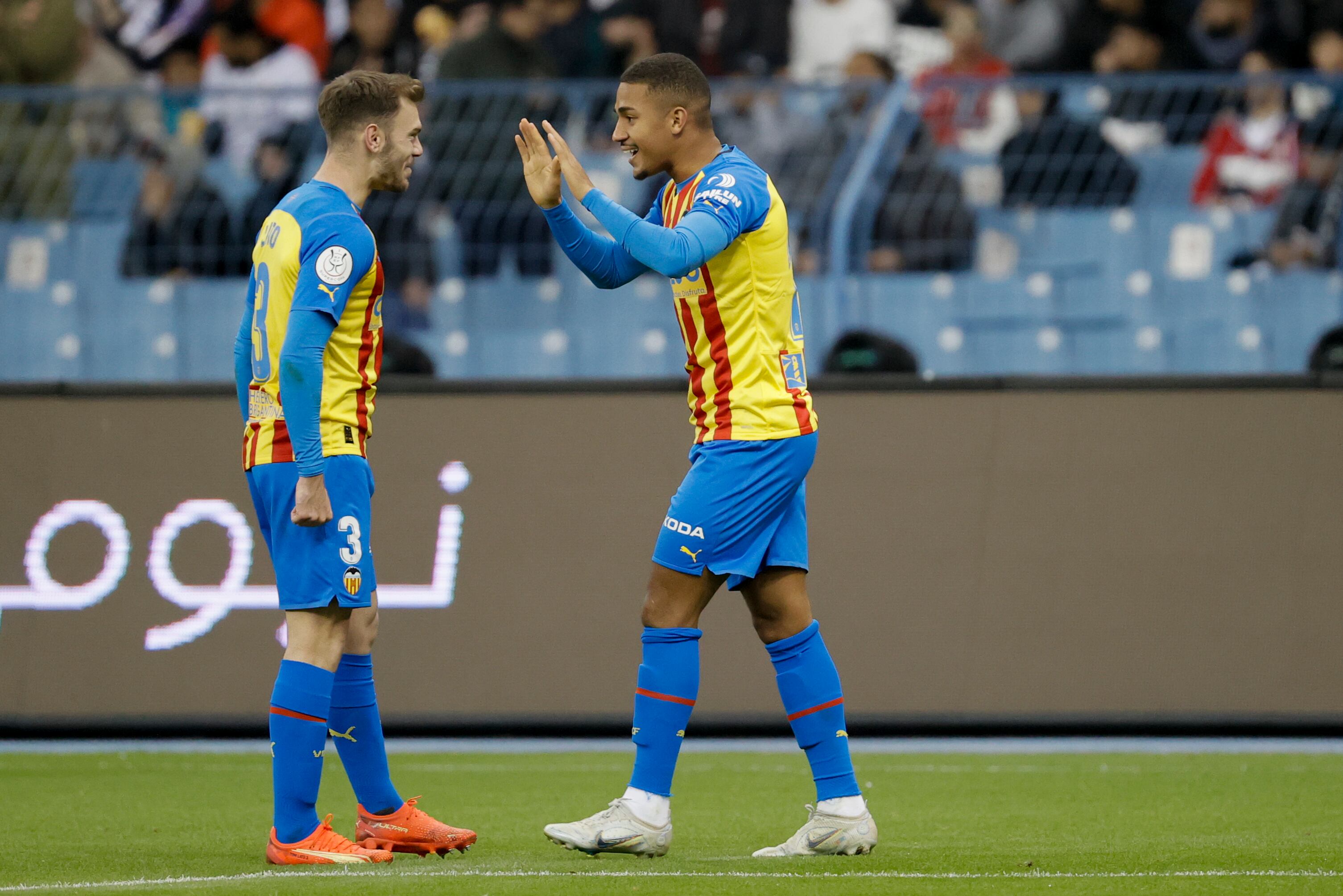 Los jugadores del Valencia, Toni Lato (i) y el brasileño Samuel Lino, celebran el primer gol del equipo valencianista durante el encuentro de semifinales de la Supercopa de España que disputan este miércoles frente al Real Madrid en el Estadio Internacional Rey Fahd, en Riad (Arabia Saudí). EFE/ Juan Carlos Cárdenas