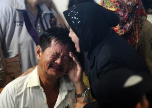 SURABAYA, INDONESIA - DECEMBER 30: Relatives of passengers on AirAsia flight QZ 8501 react to the breaking news of debris and bodies being found on December 30, 2014 in Surabaya, Indonesia. Debris and dead bodies have reportedly been sighted in the Java S