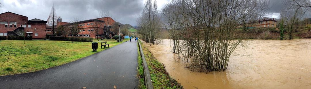 Aspecto del Río Piloña a su paso por el hospital de Arriondas, desalojado esta mañana por peligro de desbordamiento y ante la previsión de lluvia y de pleamar para esta tarde.