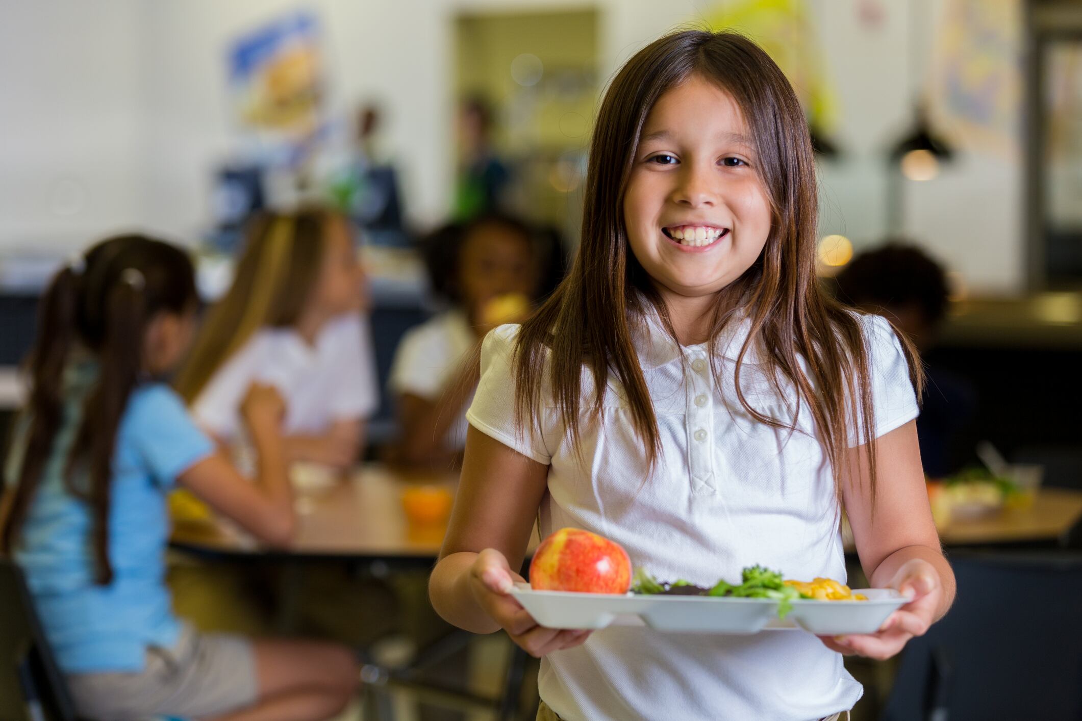 Una niña, en el comedor escolar.