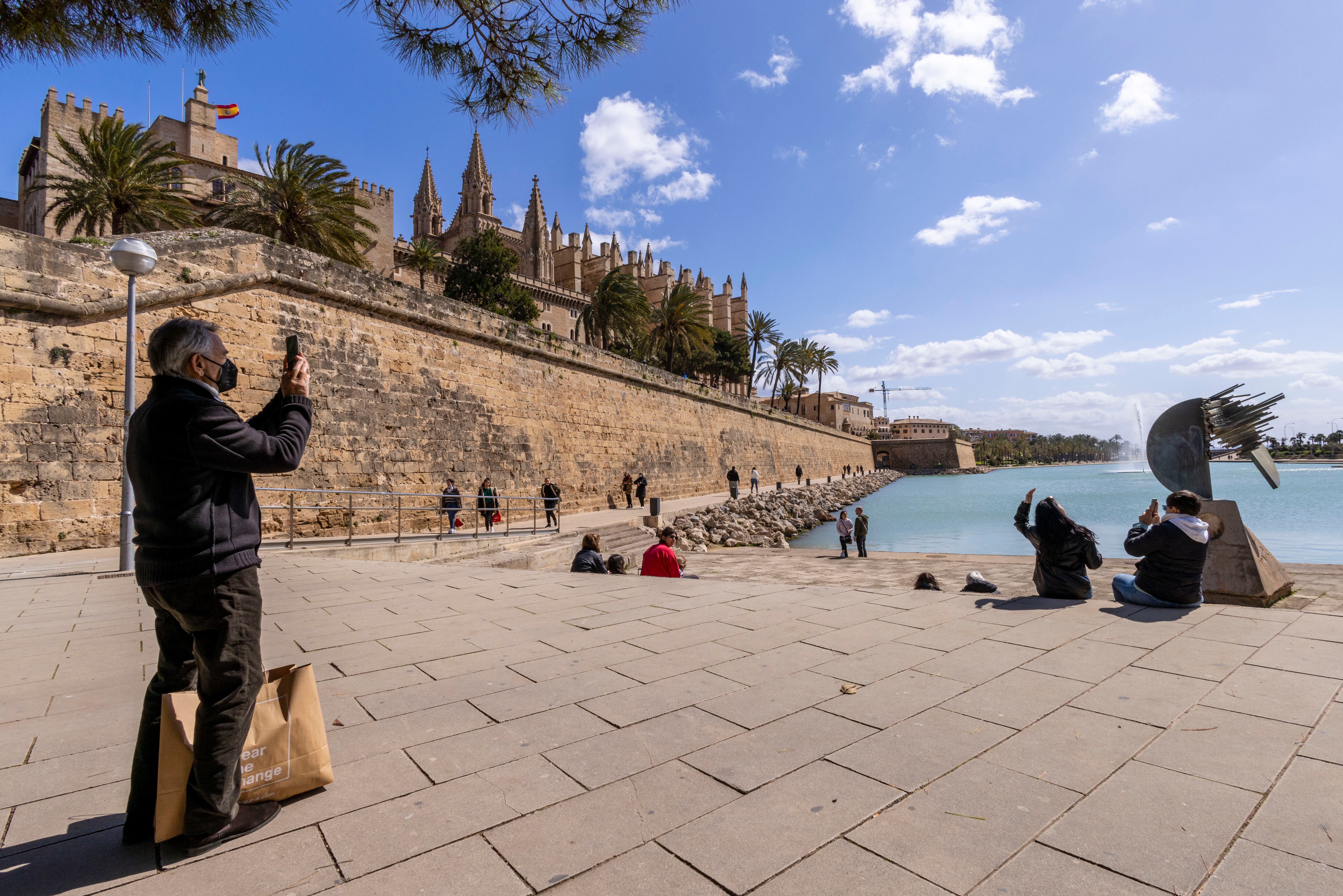 GRAF1155. PALMA DE MALLORCA, 01/04/2022.- Varios turistas se fotografián este viernes en Palma. Hoy se ha presentado en rueda de prensa el Estudio de impacto económico del turismo, Impactur Illes Baleares. EFE/CATI CLADERA
