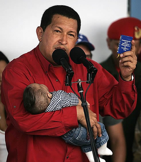 Hugo Chávez, tras votar, comparece ante los medios de comunicación con su nieto en brazos