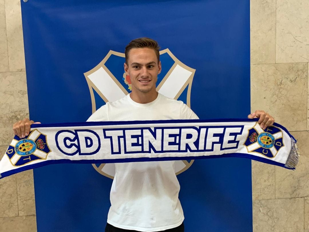 El jugador posa con la bufanda blanquiazul nada más llegar a la isla