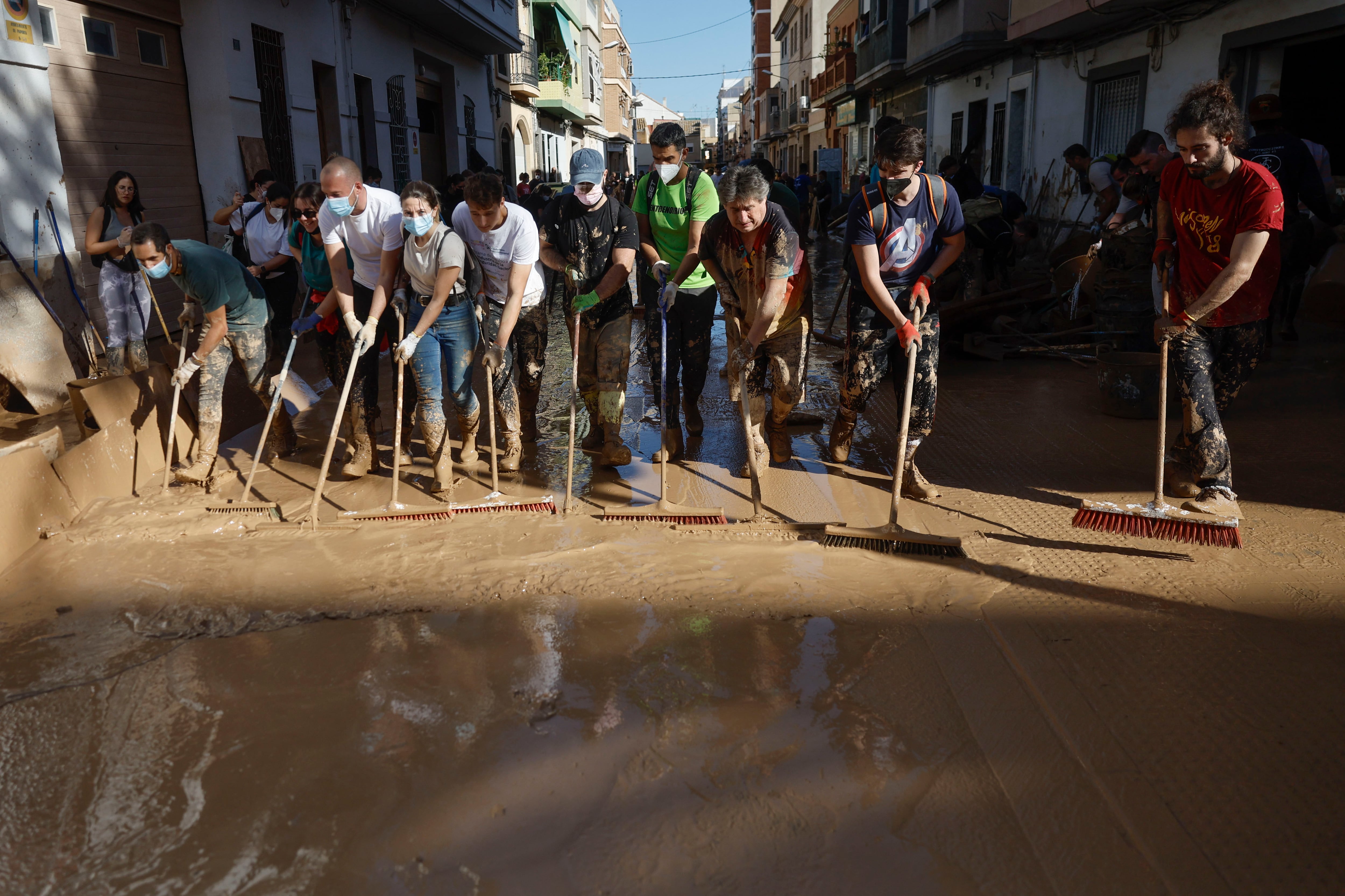 PAIPORTA (VALENCIA), 02/11/2024.- Varias personas trabajan en las labores de limpieza en la localidad valenciana de Paiporta, este sábado. Por tercer día consecutivo una marea de voluntarios ha llegado este sábado a barrios del sur de la ciudad de València y a los pueblos de la comarca vecina de lHorta Sud asolados por la dana para luchar contra un fango, donde grupos especializados de los equipos de intervención buscan cadáveres en garajes o fosos aún anegados.EFE/ Kai Försterling
