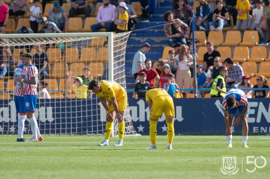 Los jugadores del Alcorcón en el césped de Santo Domingo junto a los del Girona