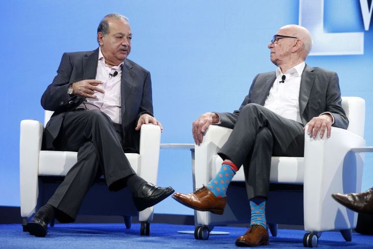 Carlos Slim (L), Lifetime Honorary Chairman, Telefonos de Mexico, speaks as Rupert Murdoch, Executive Chairman News Corp and Chairman and CEO 21st Century Fox listens, at the WSJD Live conference in Laguna Beach, California October 29, 2014.  REUTERS/Lucy