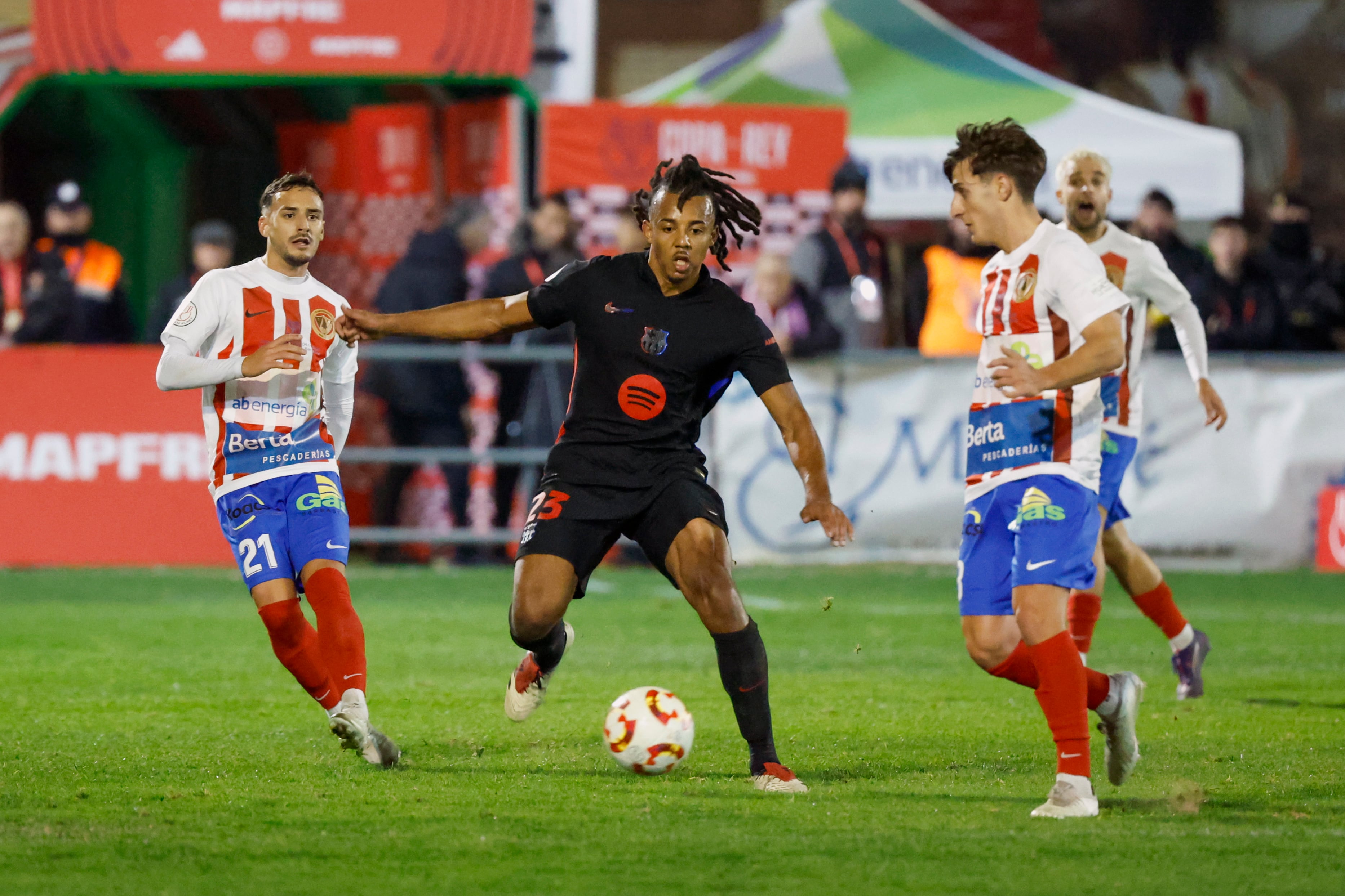 BARBASTRO (HUESCA), 04/01/2025.-El defensa francés del Barcelona Jules Koundé, y el defensa del Barbastro Sito Barrera, durante el partido de dieciseisavos de la Copa del Rey, este sábado en el Campo Municipal de Deportes de Barbastro.-EFE/ Javier Cebollada
