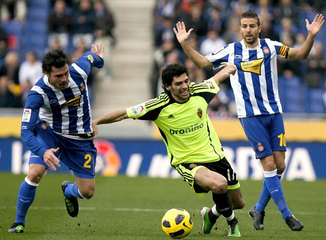 El centrocampista del Real Zaragoza Ángel Lafita lucha un balón con los jugadores del Espanyol Luis García y Javi Chica