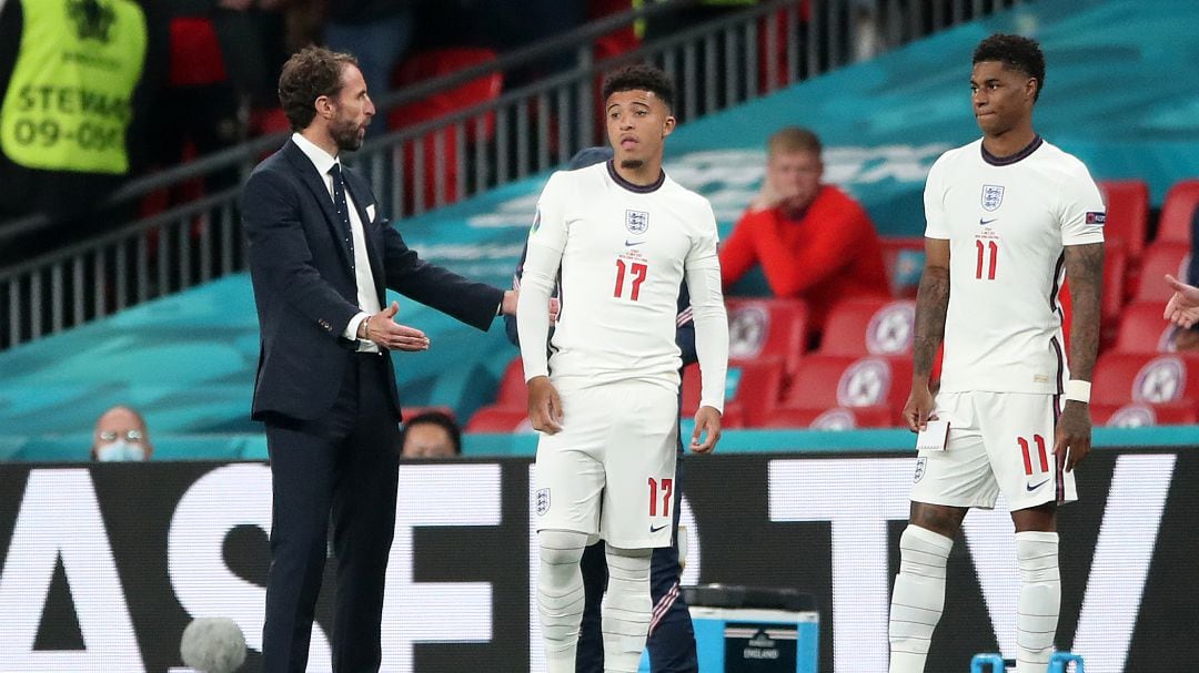 Sancho y Rashford se preparan para entrar al terreno de juego en los últimos minutos de la prórroga, ante las instrucciones de Southgate