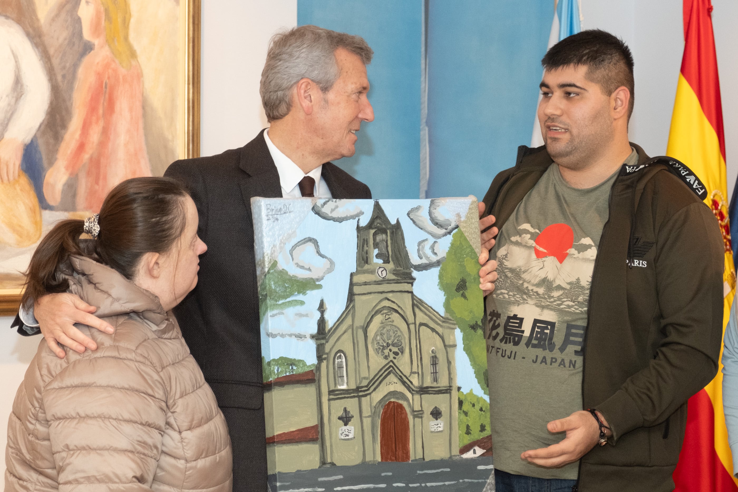 Alfonso Rueda, presidente de la Xunta, recibe de manos de los autores el cuadro por el que pujó el la Gala 40 aniversario del Centro Juan María