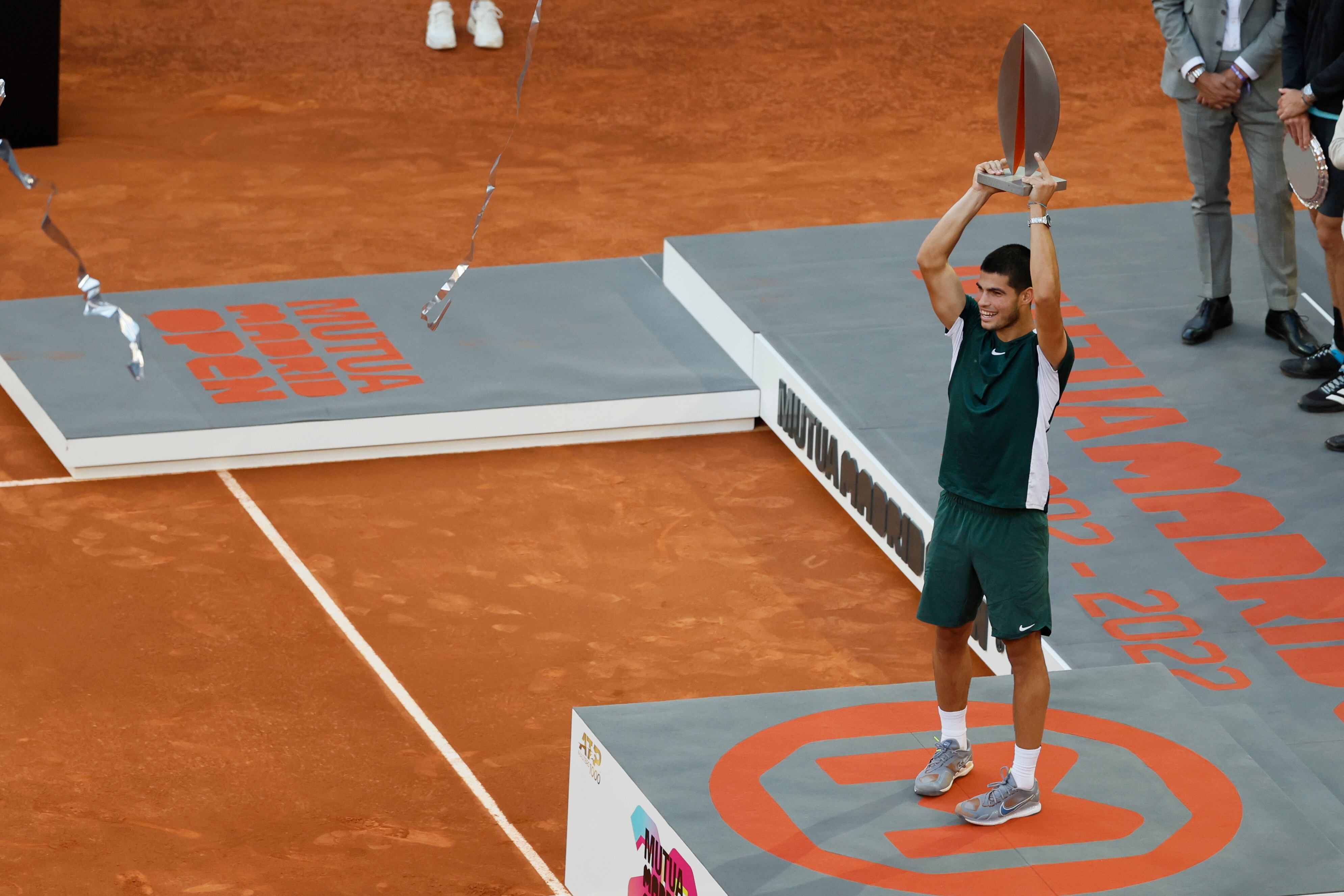 El tenista español Carlos Alcaraz con su trofeo de campeón tras la victoria en la final del Mutua Madrid Open, y derrotar al alemán Alexander Zverev en el encuentro este domingo en la Caja Mágica, en Madrid