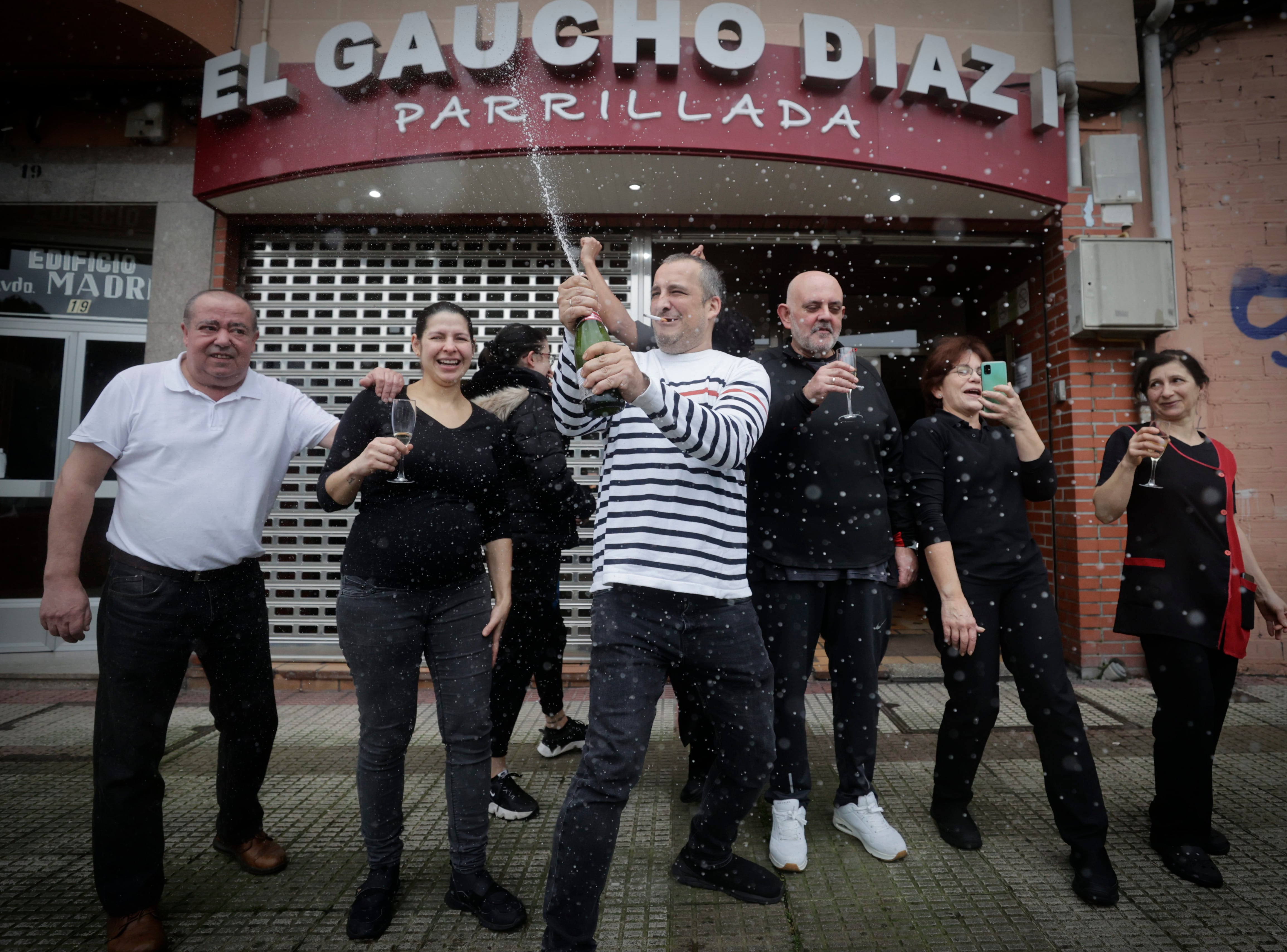 A CORUÑA, 22/12/2022.- Los trabajadores de La Parrillada El Gaucho Díaz I celebran haber vendido El Gordo, el número 05490, en 2022 en A Coruña. EFE/ Cabalar