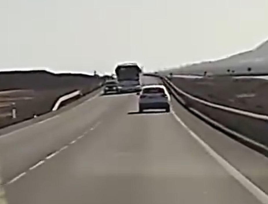 Una guagua adelanta a un turismo, de forma temeraria, en la carretera LZ-2 entre Yaiza y Playa Blanca, en la isla de Lanzarote.