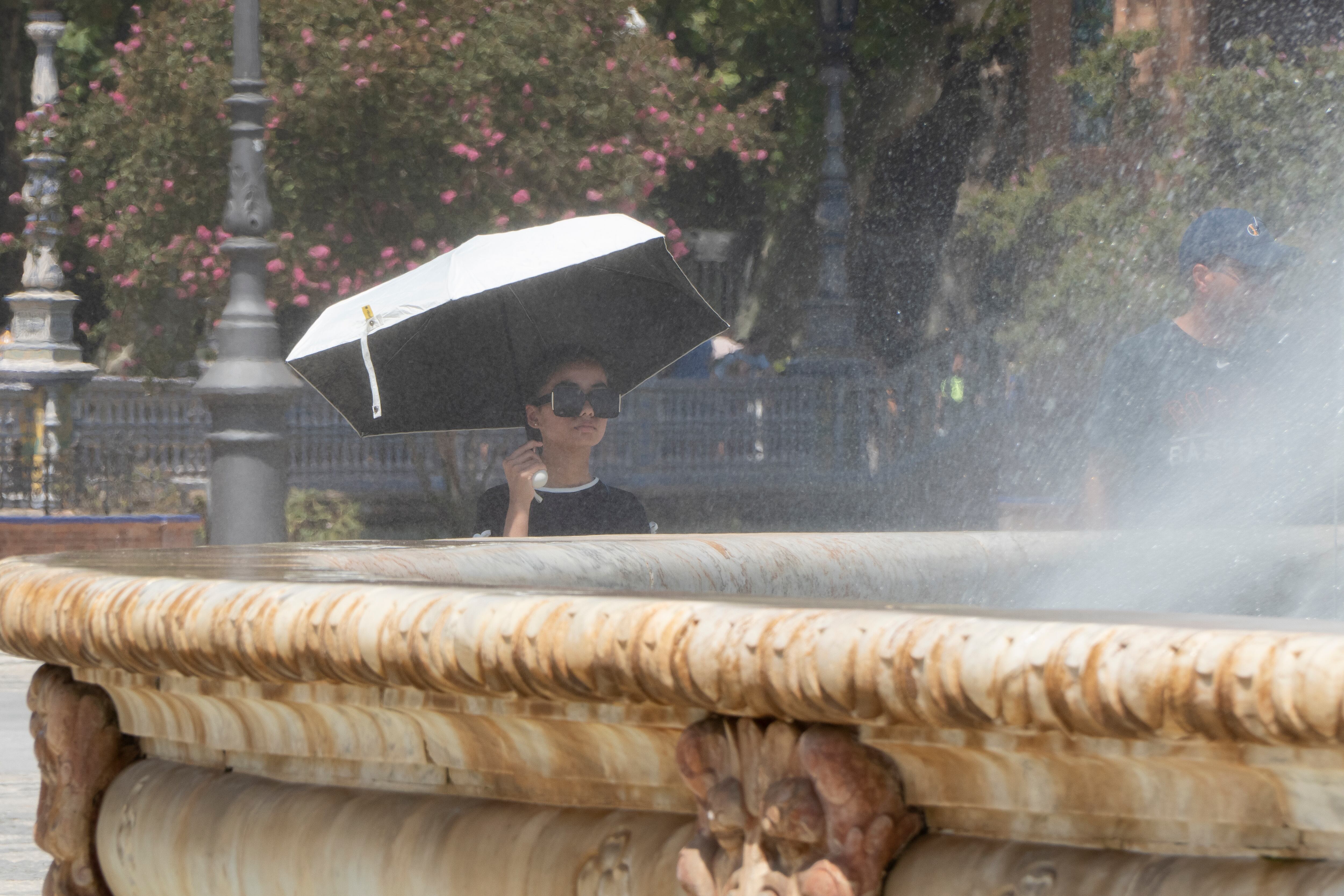 Las fuentes y sombrillas son recursos para aliviar la sensación durante la ola de calor. EFE/David Arjona.