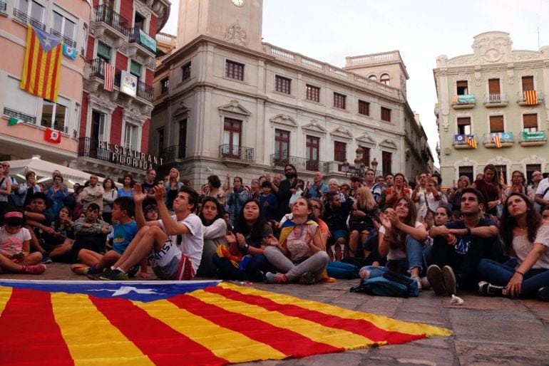 Jóvenes y niños siguiendo la declaración de Puigdemont en la plaza de Reus