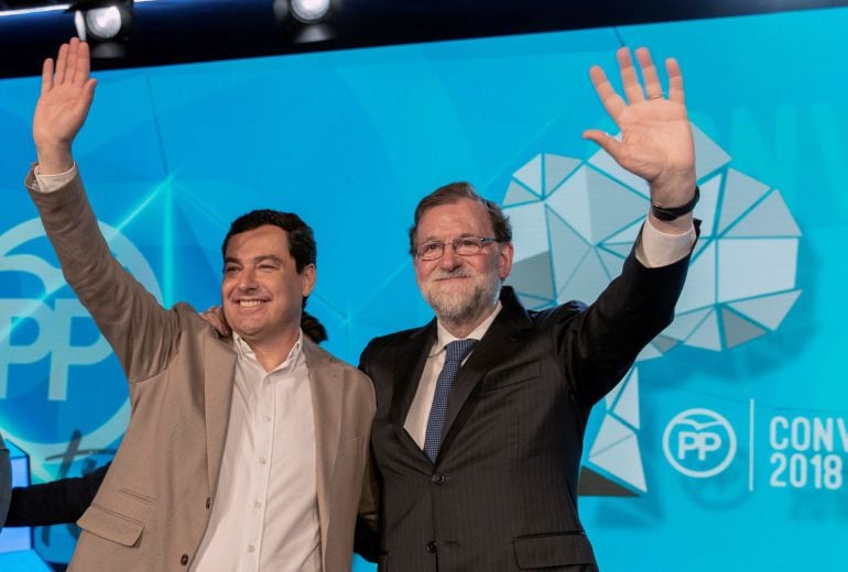 El presidente del Gobierno, Mariano Rajoy, y el presidente del PP andaluz, Juanma Moreno, saludan en el acto de clausura de la Convención Nacional del PP hoy en Sevilla. EFE Julio Muñoz