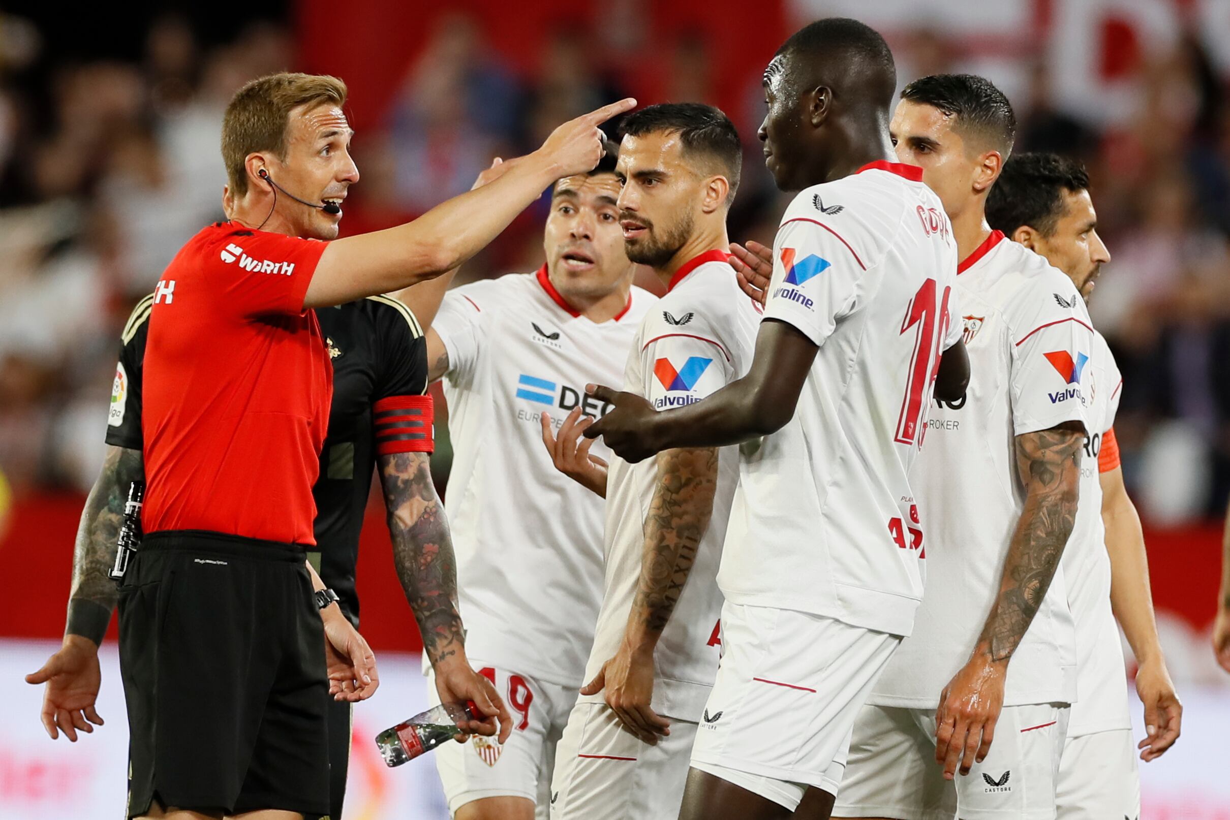 SEVILLA, 07/04/2023.- El árbitro Pizarro Gómez (i) expulsa a Pape Alassane Gueye (3-d), del Sevilla, durante el partido de Liga en Primera División que Sevilla FC y Celta de Vigo disputan este viernes en el estadio Ramón Sánchez-Pizjuán. EFE/José Manuel Vidal
