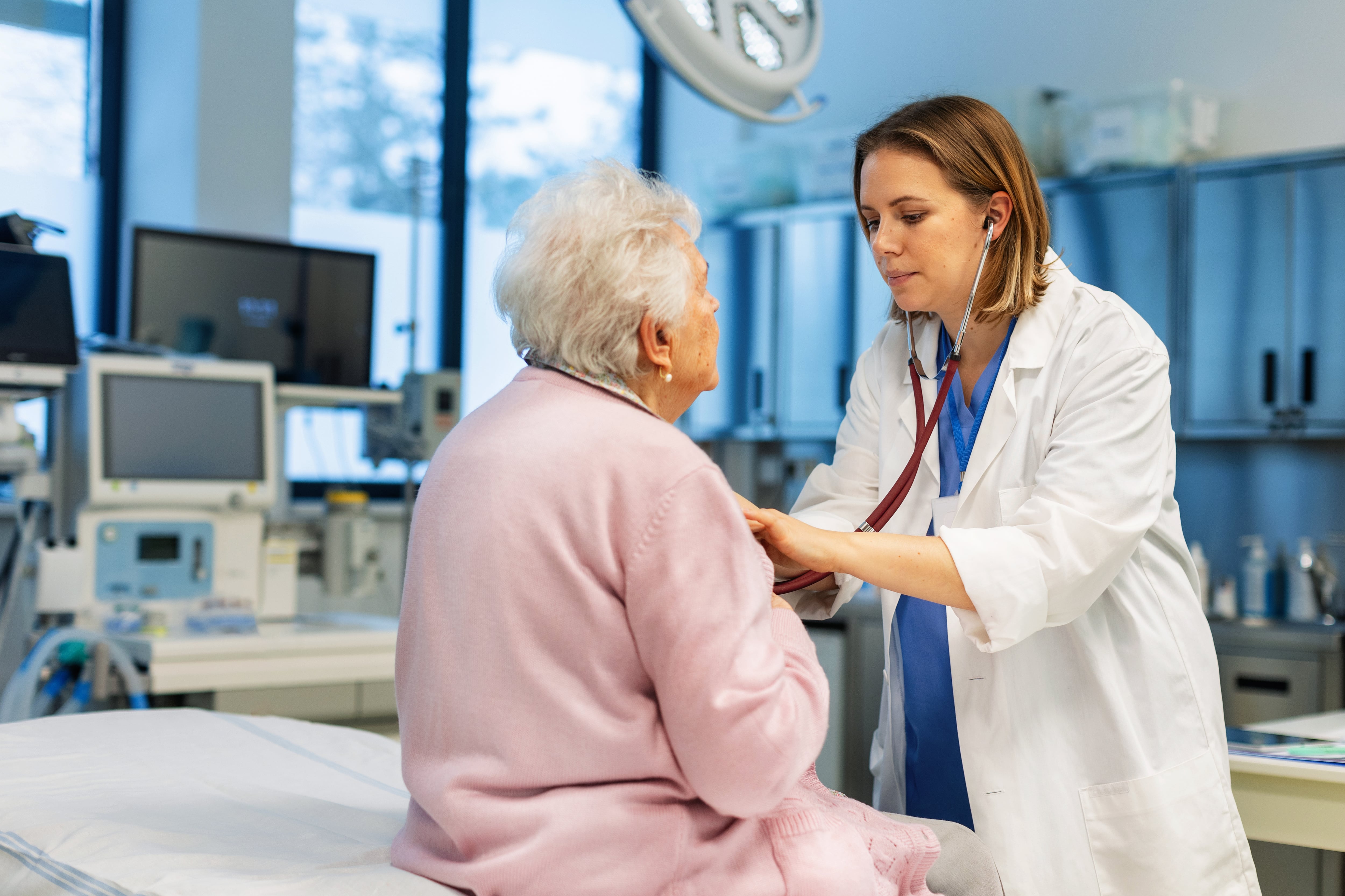 Doctor listening senior woman&#039;s breathing, heartbeats using a stethoscope. Elderly patient have problem with breathing, chest pain, heart palpations. Concept of preventive health care for elderly people.