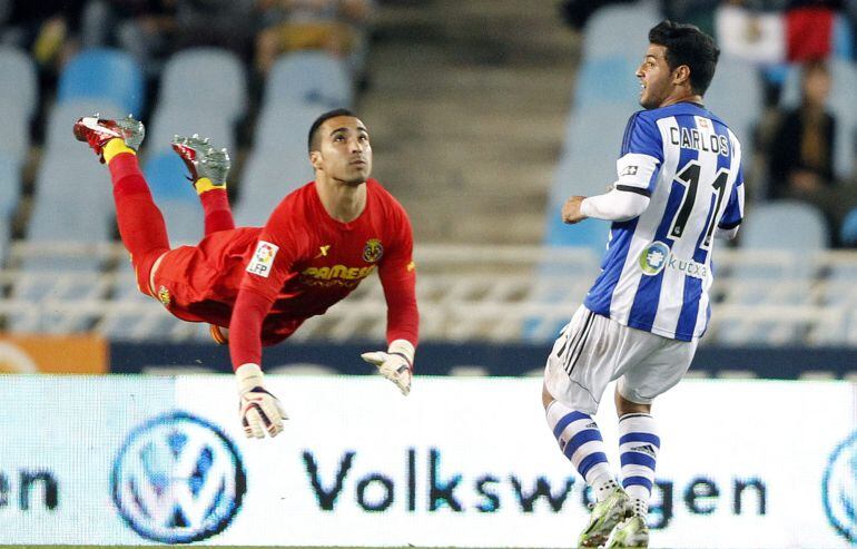 GRA468. SAN SEBASTIÁN. 25/04/2015-. El portero del Villarreal Sergio Asenjo (i) depeja un balón ante el mexicano Carlos Vela, de la Real Sociedad, durante el partido de la jornada trigésimo tercera de Liga que se disputa esta noche en el estadio de Anoeta