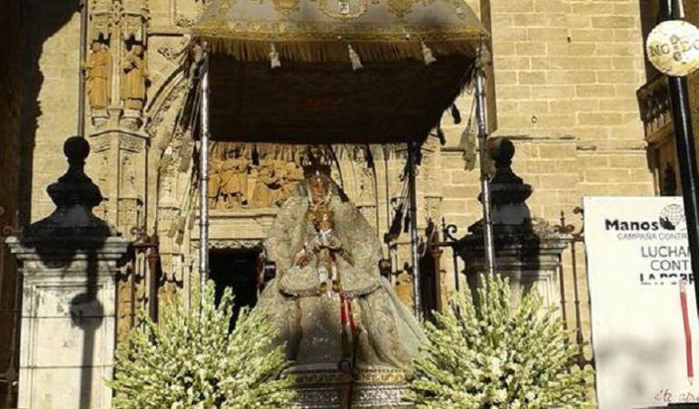 El palio de tumbilla de la Virgen de los Reyes a punto de vovler a entrar en la Catedral por la Puerta de Palos
