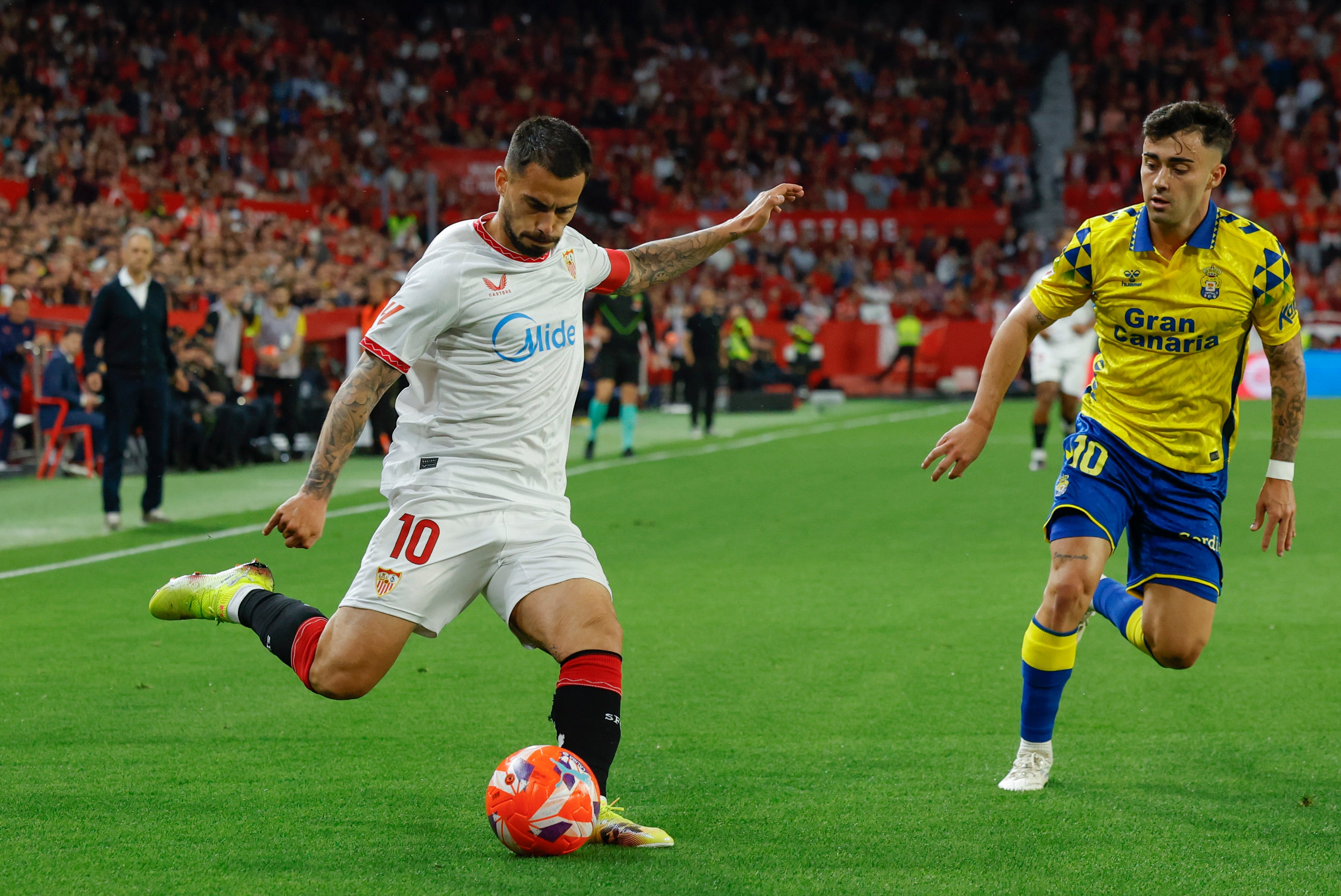 SEVILLA, 13/05/2025.- El centrocampista del Sevilla FC Suso (i) lucha el balón con el centrocampista de la UD Las Palmas Alberto Moleiro (d) durante el partido de la jornada 36 de LaLiga que Sevilla FC y UD Las Palmas disputan este martes en el estadio Ramón Sánchez-Pizjuán. EFE/Julio Muñoz

