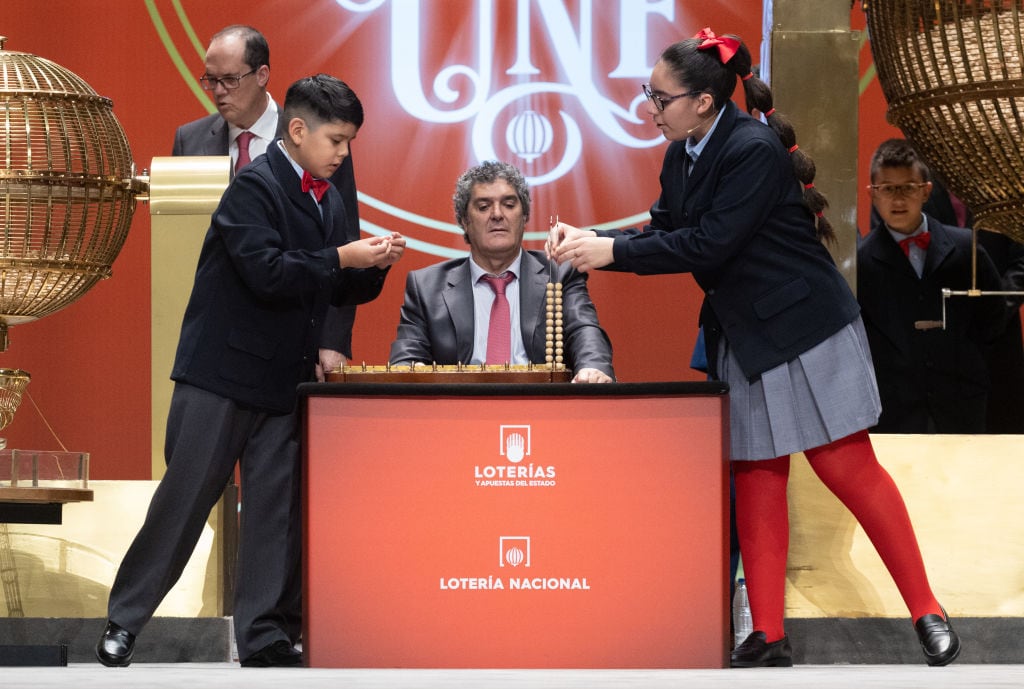 Dos niños de San Ildefonso extraen los números premiados y los premios durante el Sorteo de la Lotería de Navidad.