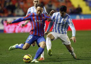 El centrocampista del Levante Jordi Xumetra disputa el balón con el delantero del Málaga Javi Guerra