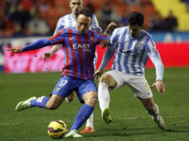 El centrocampista del Levante Jordi Xumetra disputa el balón con el delantero del Málaga Javi Guerra