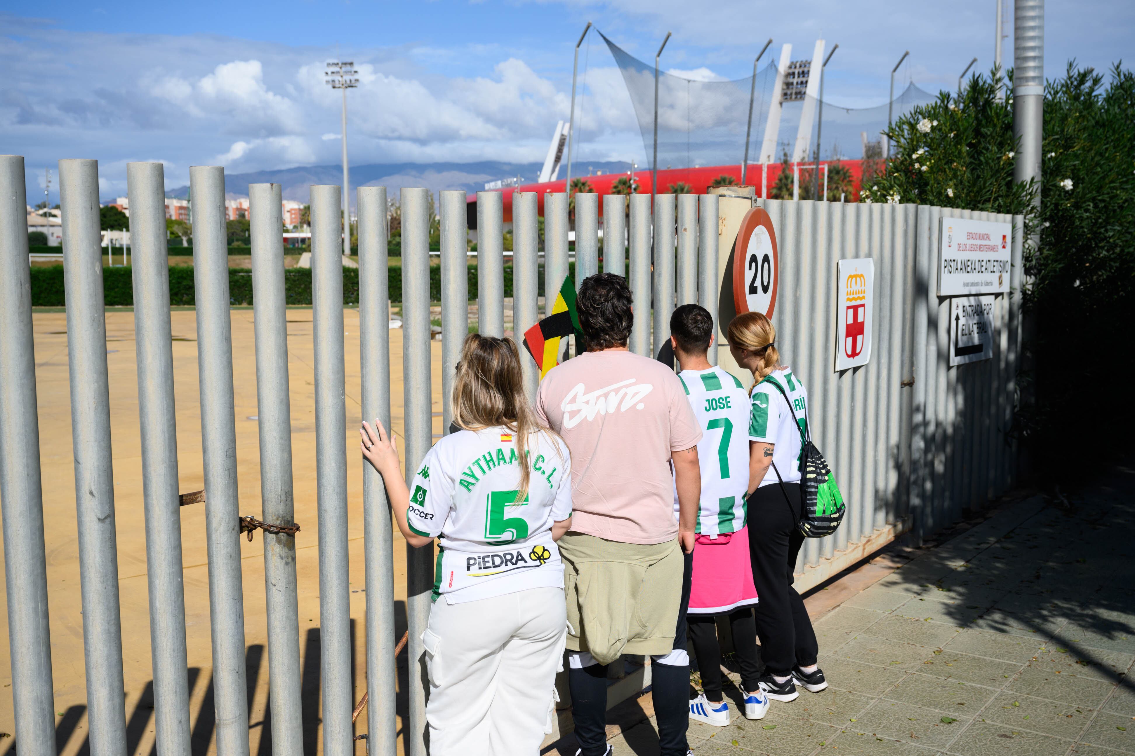 Aficionados del Córdoba contemplando un Estadio de los Juegos Mediterráneos en silencio.