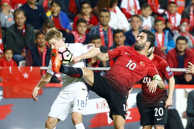 Arda Turan disputa el balón durante el partido contra Finlandia