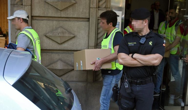 Agentes de la Guardia Civil sacan esta tarde material del edificio donde se encuentra la sede de Efial en Barcelona, donde se ha efectuado un registro en el marco de una operación contra la corrupción municipal.