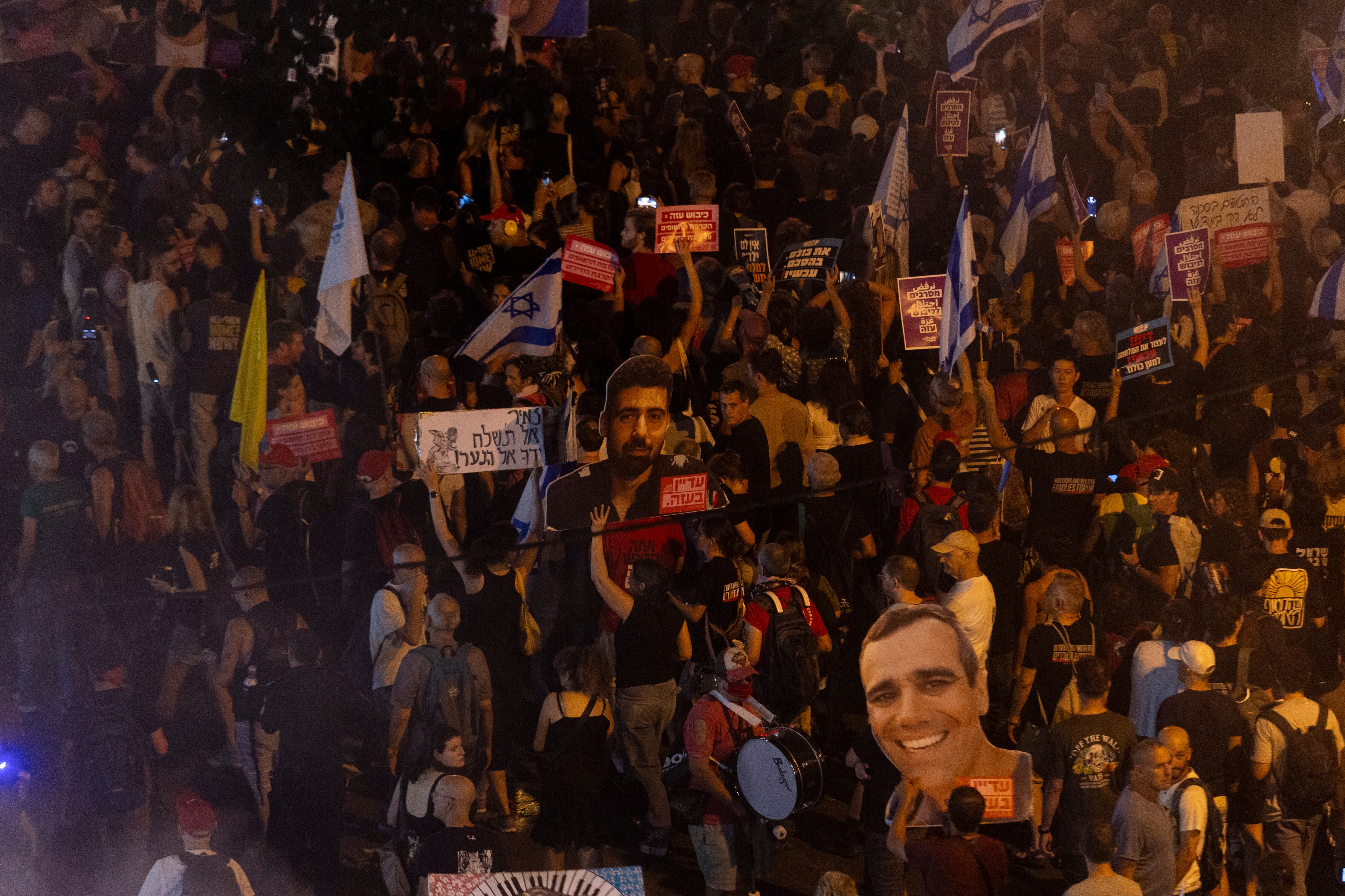 TEL AVIV, ISRAEL - AUGUST 7: Protesters hold photos of hostages held in the Gaza Strip during a protest calling for a hostages deal on August 7, 2025 in Tel Aviv, Israel. Local media reports that Israeli Prime Minister Benjamin Netanyahu is seeking backing from his security cabinet for the "full occupation" of the Gaza Strip, despite warnings from security officials and human rights groups that such a move could further endanger the lives of hostages still believed to be held alive by Hamas, as well as Palestinians already suffering displacement and an acute hunger crisis in Gaza. (Photo by Amir Levy/Getty Images)