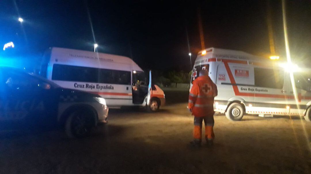 Voluntarios de Cruz Roja, anoche, atendiendo a los ocupantes de la patera que llegó a la playa de La Cola 