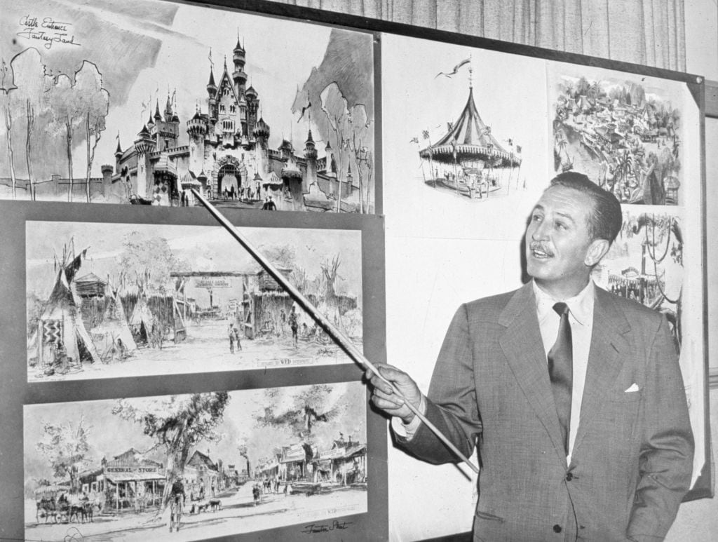 American producer, director, and animator Walt Disney (1901 - 1966) uses a baton to point to sketches of Disneyland, 1955. (Photo by Hulton Archive/Getty Images)